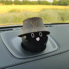 NOMI is wearing a brown leather bucket hat with brown stars printed on it.