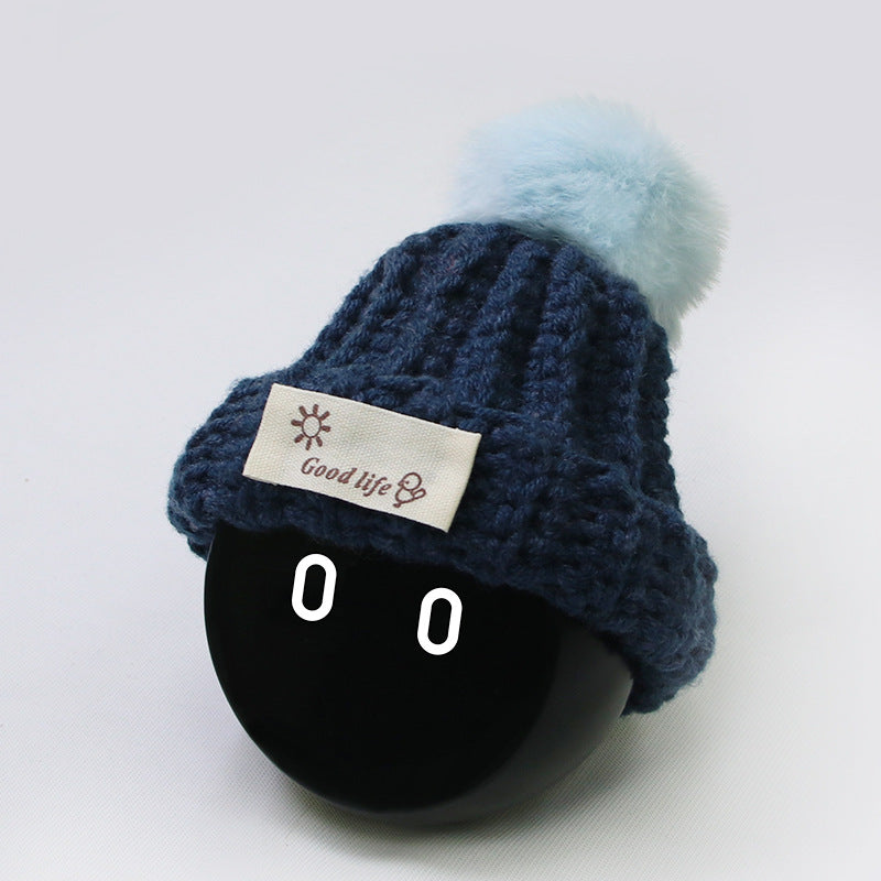 Navy blue hat with light blue ball.