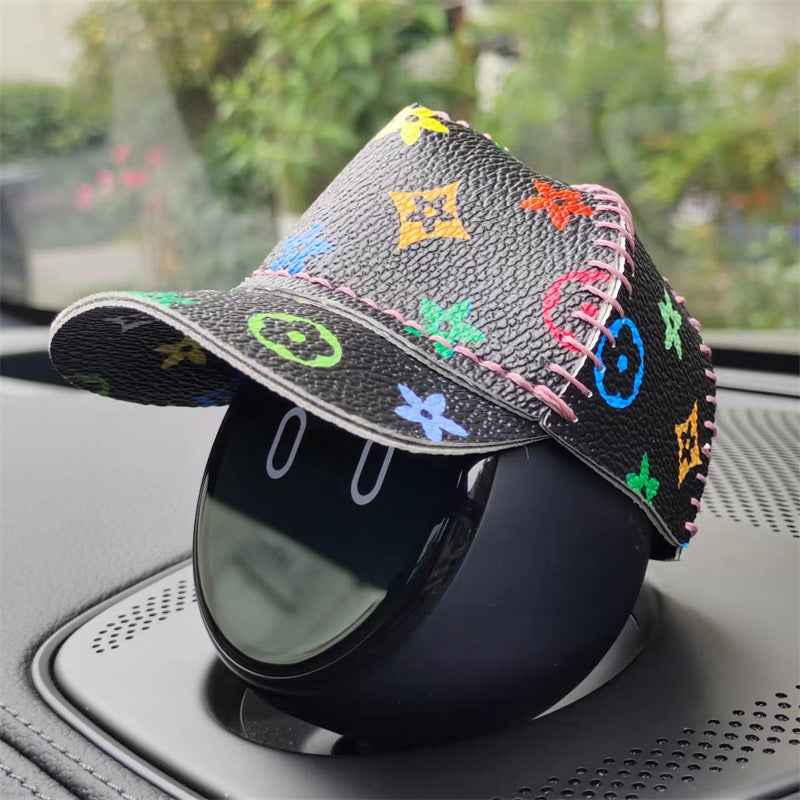 Black leather cap with colorful floral print.