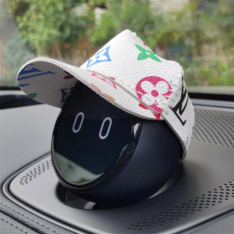 NOMI wears a white leather baseball cap with colorful prints on it.